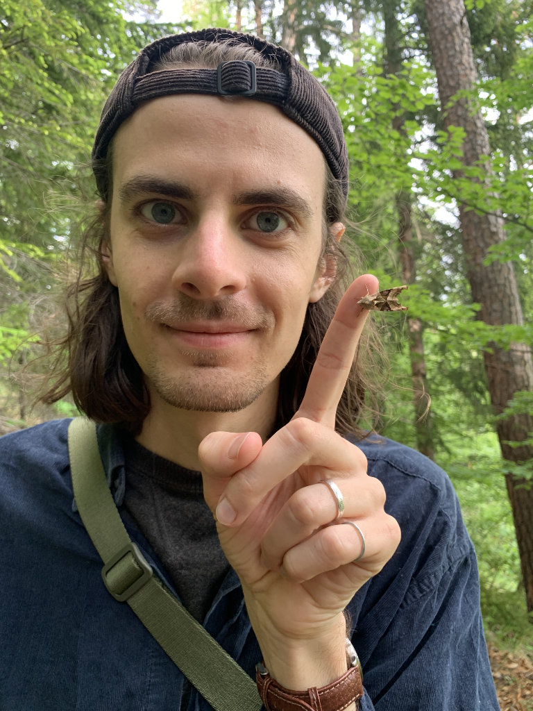 Profile photo of Gregory Manni holding a moth on his finger